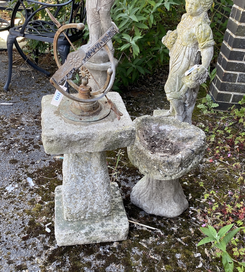 A sphere sundial on reconstituted stone plinth, height 85cm, and a smaller shell shaped bird bath